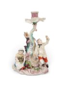 A rare Chelsea candlestick figure group, c.1755, emblematic of Autumn, modelled with two vintners, t