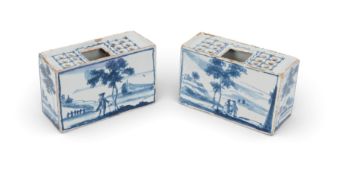 A pair of small delftware flower bricks, c.1770, the rectangular forms painted in blue with European
