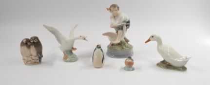 Five Royal Copenhagen bird groups, one of a young boy with two geese, another goose, a penguin, a gr