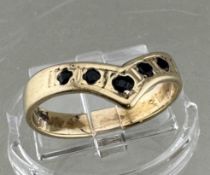 A 9ct yellow gold and sapphire ring from Zimbabwe, set with five small stones, size M, 2.3g.