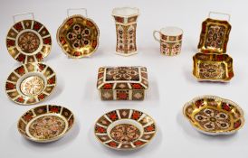 A Royal Crown Derby coffee can and six varying saucers, modern, richly decorated in the Imari palett