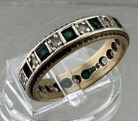 A 9ct white gold emerald and diamond eternity ring, some stones missing, size Q, 4.3g.