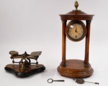 A portico mantel clock, late 19th century, the flowered dial with Arabic numerals, flanked by four w