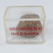 Social History: an Italian perspex cased stone sample from Hiroshima, taken after the 1945 atomic bo