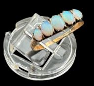 Jewellery: a 9ct rose gold ring set with five graduated opals, UK size R, 1.75g.
