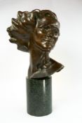 Decorative Arts: an early 20th century bronze bust of a windswept young woman, signed 'Merrett 1931'