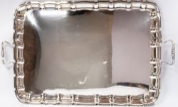 Silver: a plain rectangular two handled tray by William Hutton, London 1907, with scalloped and pie 