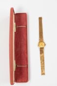 Watches: a ladies 9ct gold wristwatch by Bueche Girod, with integral strap. Diameter 24mm including 