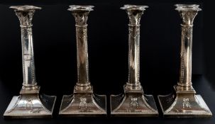 Silver: a fine set of four George V Corinthian column candlesticks, London 1911-12, decorated with s