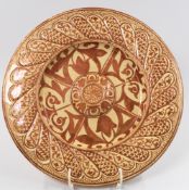 Ceramics: a late 19th century Hispano Moresque lustre plate, a central boss within a well, the borde