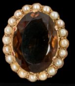 Jewellery: a yellow metal brooch, testing as gold, set a central smoky quartz approximately 25mm by 