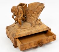 Treen: a lindenwood carved table match striker, probably Black Forest, modelled as an anthropomorphi