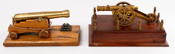 Two brass models of cannons, 20th century, mounted on wooden bases, one with a firing hole, the othe