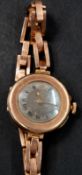 Watches: an unsigned 9ct gold trench style watch, pin set, on expanding Britannic gold strap, diamet