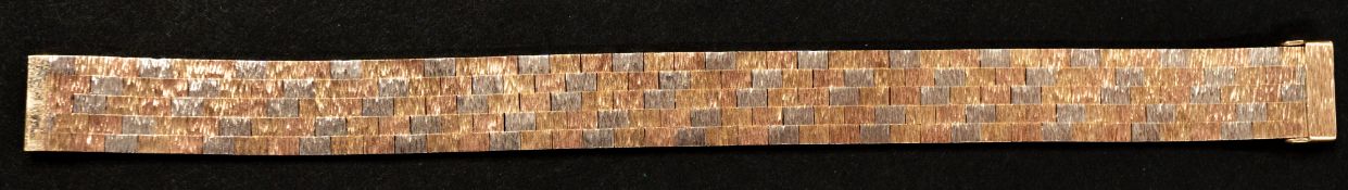 Jewellery: a three colour brushed 9ct gold mesh bracelet, London 1972. 17.5cm long, 1.3cm deep, 29.6