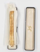 Jewellery: a yellow metal bracelet, bearing continental marks and testing as gold, of double banded 