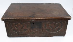 Furniture: an 18th century oak bible box, with trilobed leaf motifs to each side within S scrolls fo