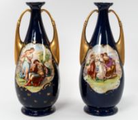Ceramics: a pair of Austrian Royal Vienna style blue ground vases of two handled urn form, each with