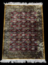 Rugs: a 20th century Bokhara rug, deep red diamonds within a pale brown and blue hatched border. App