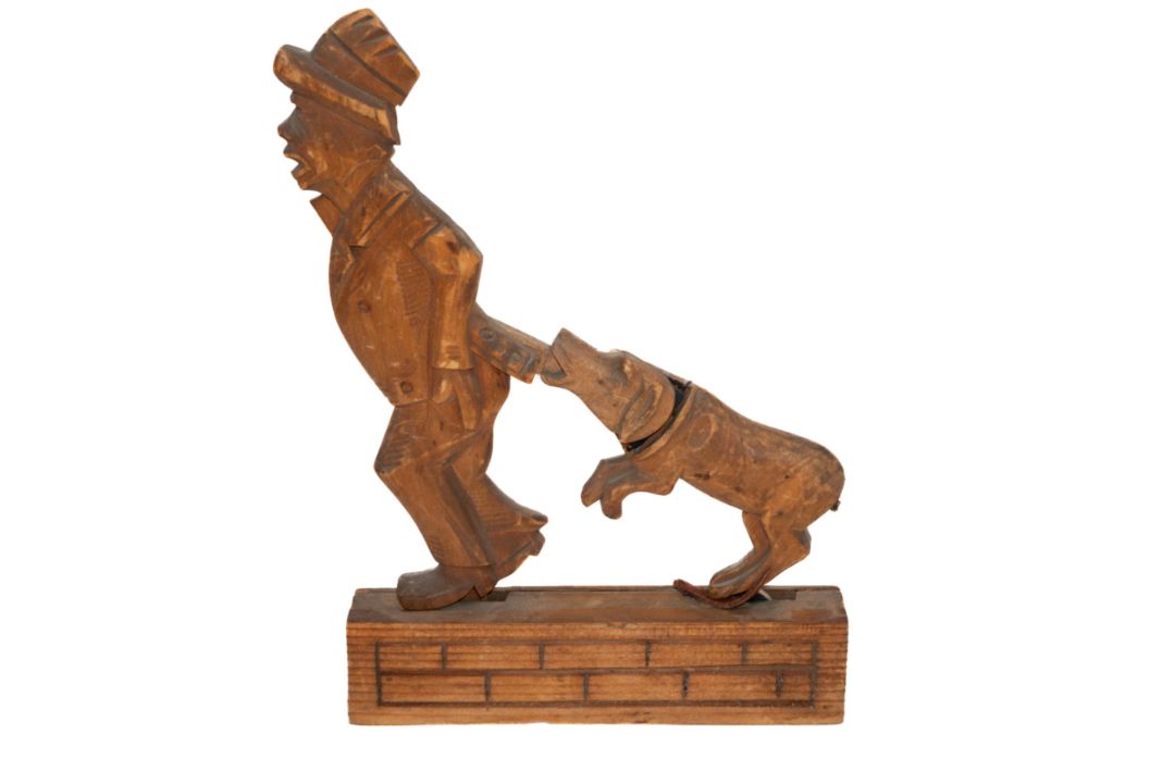 Treen: an articulated Black Forest desktop toy carved as a man having his coat pulled by a dog, tail - Image 2 of 3