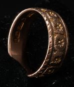 Jewellery: a 9ct rose gold band, Birmingham 1890, with engraved star decoration within a double chan