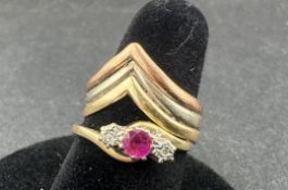 Jewellery: a 9ct yellow gold ring set two small diamonds around a central red stone, UK size N, toge