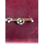 Jewellery: a yellow metal bar brooch, unmarked but testing as 18ct gold, a central crescent set alte