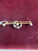 Jewellery: a yellow metal bar brooch, unmarked but testing as 18ct gold, a central crescent set alte