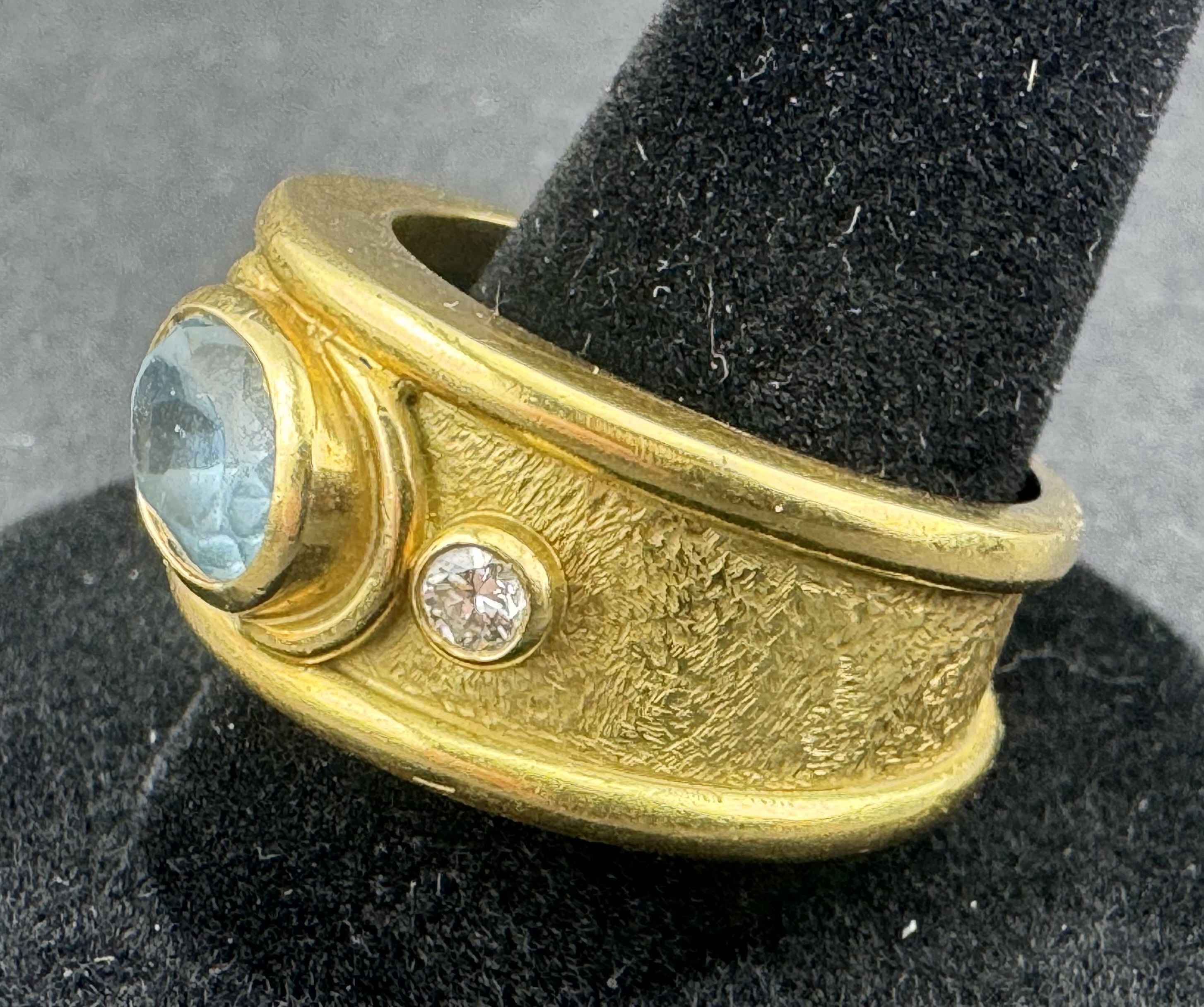 Jewellery: an unmarked yellow metal ring, testing as 18ct gold, collet set with an oval aquamarine m - Image 2 of 4