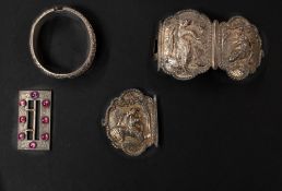 Silver: a Burmese white metal three section belt buckle, decorated in high relief with native figure