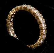 Jewellery: a yellow metal and diamond full eternity ring, testing as 18ct gold but evidently unmarke