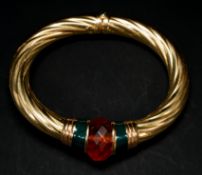 Jewellery: an Italian yellow metal sprung bangle of wrythen form, marked 750 and testing as 18ct gol
