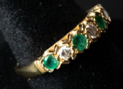 Jewellery: an 18ct yellow gold ring set a row of four emeralds divided by diamonds, UK size P, 3.5g.