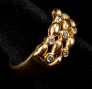 Jewellery: a yellow metal ring, marked 'K18' and testing as 18ct gold, set with seven small diamonds