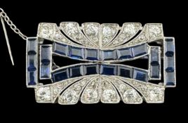 Jewellery: an Art Deco white metal brooch, testing as platinum, two non parallel rows of calibre set