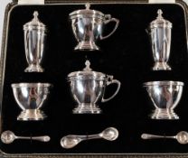 Silver: a boxed six piece cruet set by A Chick & Sons Ltd, London 1973, each piece with a steppe