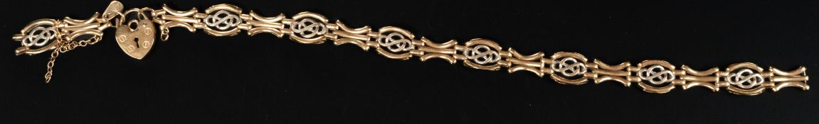 Jewellery: a 9ct gold open fancy link two colour bracelet with heart shaped clasp, broken. 20.5cm, 8