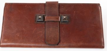 Fashion: A Hermes Medor clutch bag, believed 1980s, of leather construction with typical brass pyram