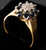 Jewellery: a 9ct yellow gold ring star set a central diamond within a halo of eight sapphires, UK si