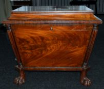 Furniture: an early 19th century mahogany cellarette of sarcophagus form, standing upon four paw fee