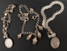 Silver: two white metal lockets on ornate chains, one engraved with an image of Bo Peep sat forlornl