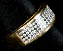 Jewellery: an unmarked yellow metal ring, testing as 18ct gold, set a panel of white stones, UK size