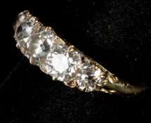 Jewellery: an early 20th century yellow metal and five stone diamond ring, the band testing as 18ct 