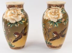 Oriental: a pair of early 20th century Japanese baluster vases, probably Satsuma, painted with a con