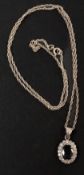 Jewellery: a white metal pendant set a central sapphire within a halo of diamonds, a further diamond