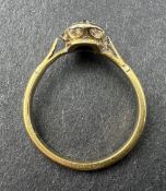Jewellery: a yellow metal ring, unmarked but testing as 18ct gold, set a cracked green stone within 