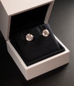 Jewellery: De Beers- a pair of solitaire round brilliant cut diamond earrings, each 1.5ct stone asse