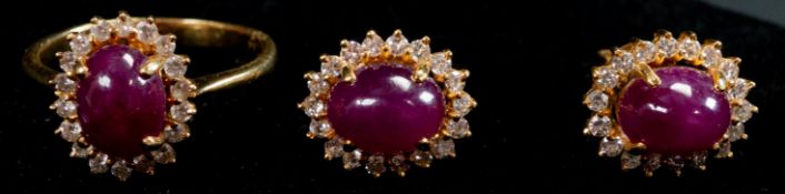 Jewellery: a yellow metal ring, marked 18k and testing as gold, set an oval cabochon cut ruby within
