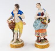 Ceramics: a Sitzendorf figurine of a young man holding a cage, a bird perched upon it, 19.5cm, toget