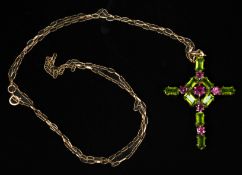 Jewellery: an open cross pendant, set with peridots and amethysts, on a 9ct yellow gold trace chain,